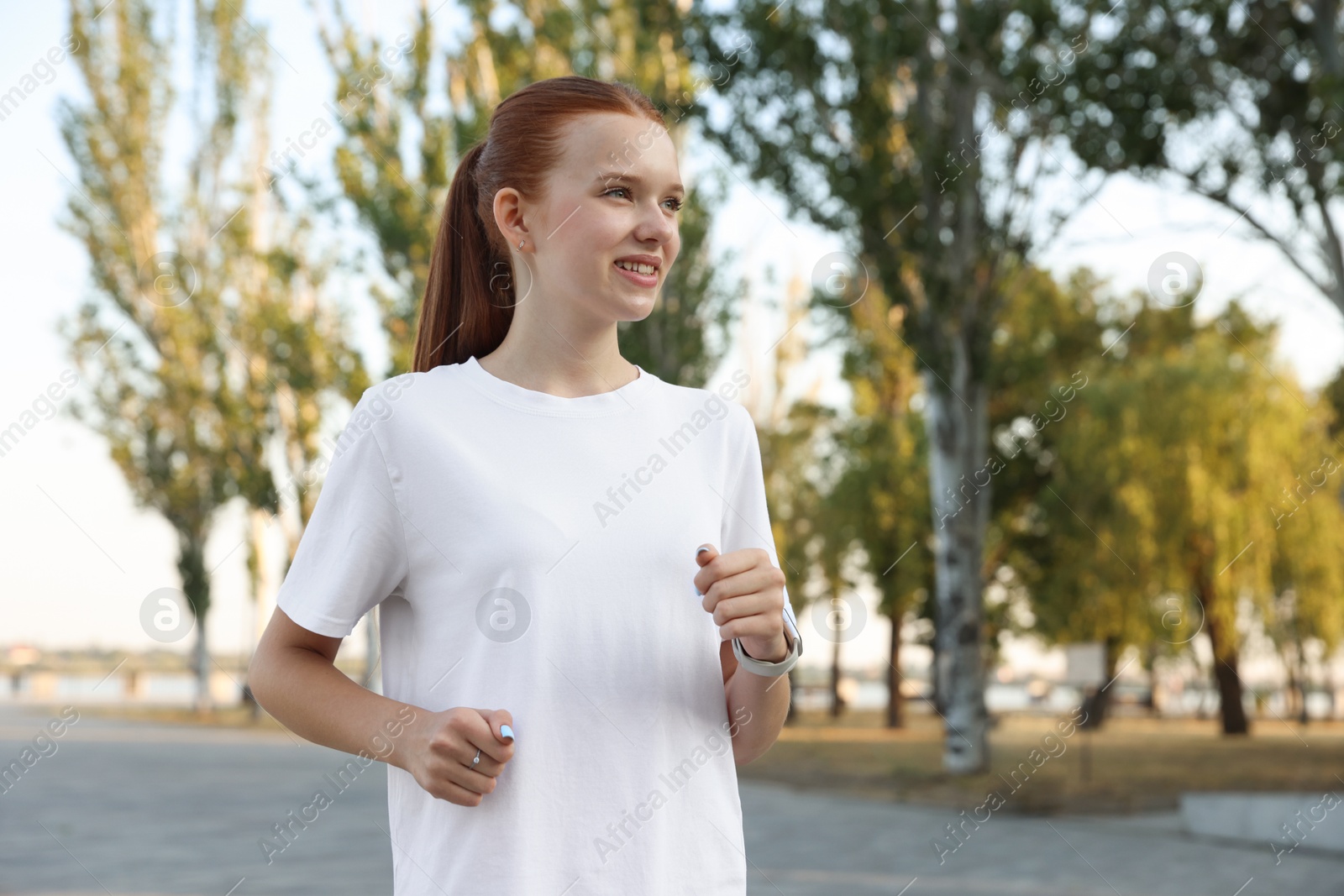 Teenage girl jogging in park. Morning run Photo of Teenage girl jogging in park. Morning run