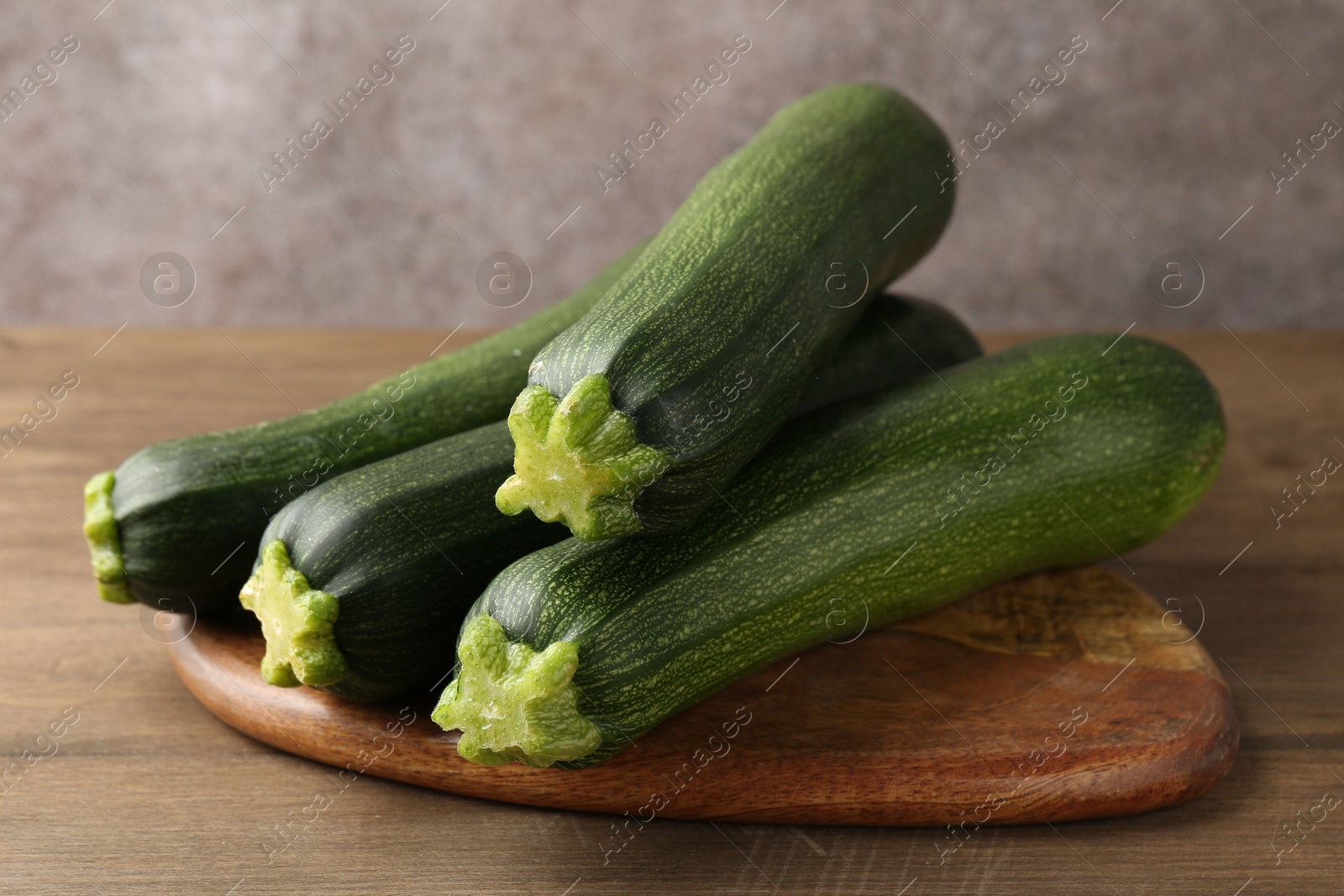 Fresh ripe zucchinis on wooden table, closeup Photo of Fresh ripe zucchinis on wooden table, closeup