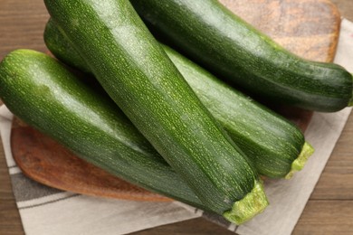 Photo of Fresh ripe zucchinis on wooden table, top view