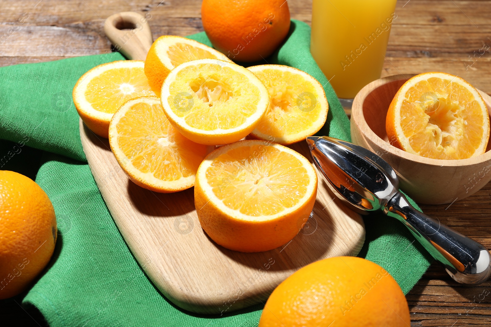 Fresh oranges and juicer on wooden table, closeup Photo of Fresh oranges and juicer on wooden table, closeup