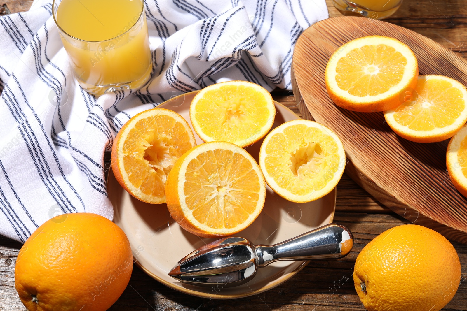 Freshly squeezed orange juice, fruits and juicer on wooden table, above view Photo of Freshly squeezed orange juice, fruits and juicer on wooden table, above view