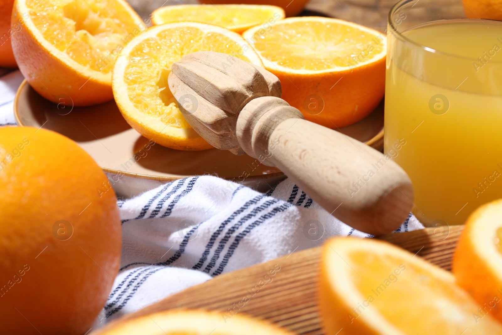 Freshly squeezed orange juice, fruits and juicer on table, closeup Photo of Freshly squeezed orange juice, fruits and juicer on table, closeup