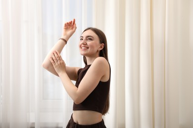 Photo of Beautiful woman posing near window at home