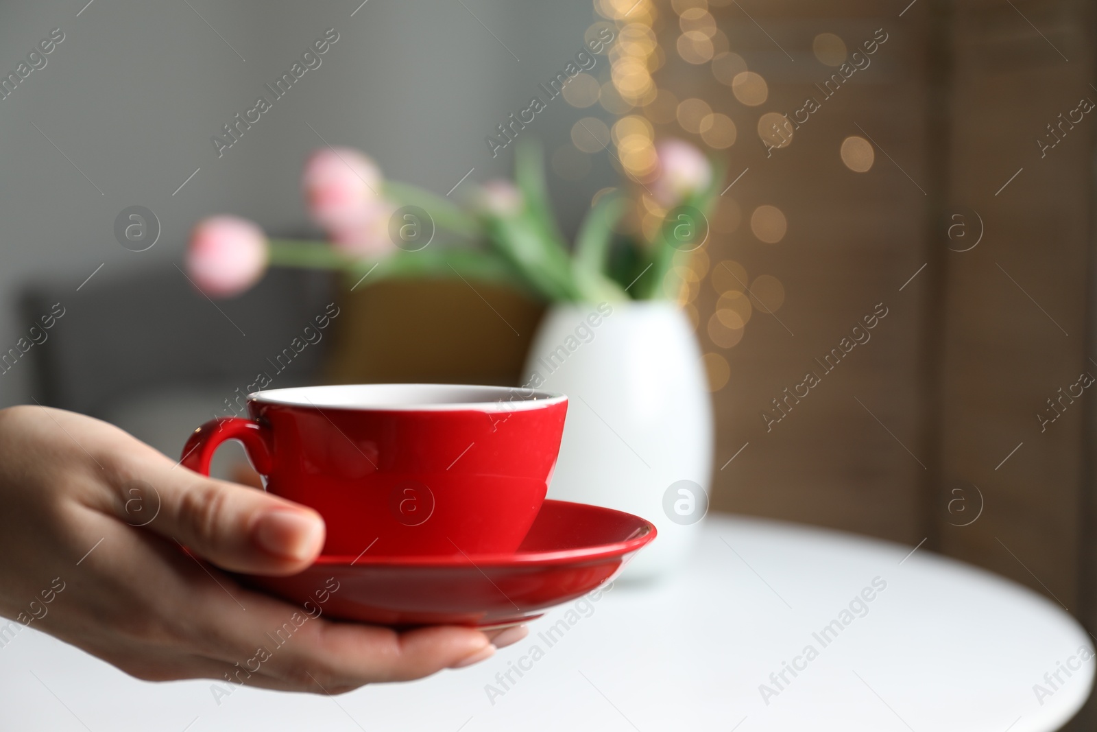 Woman with cup of tea at home, closeup Photo of Woman with cup of tea at home, closeup