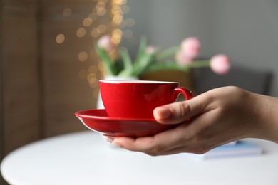 Photo of Woman with cup of tea at home, closeup