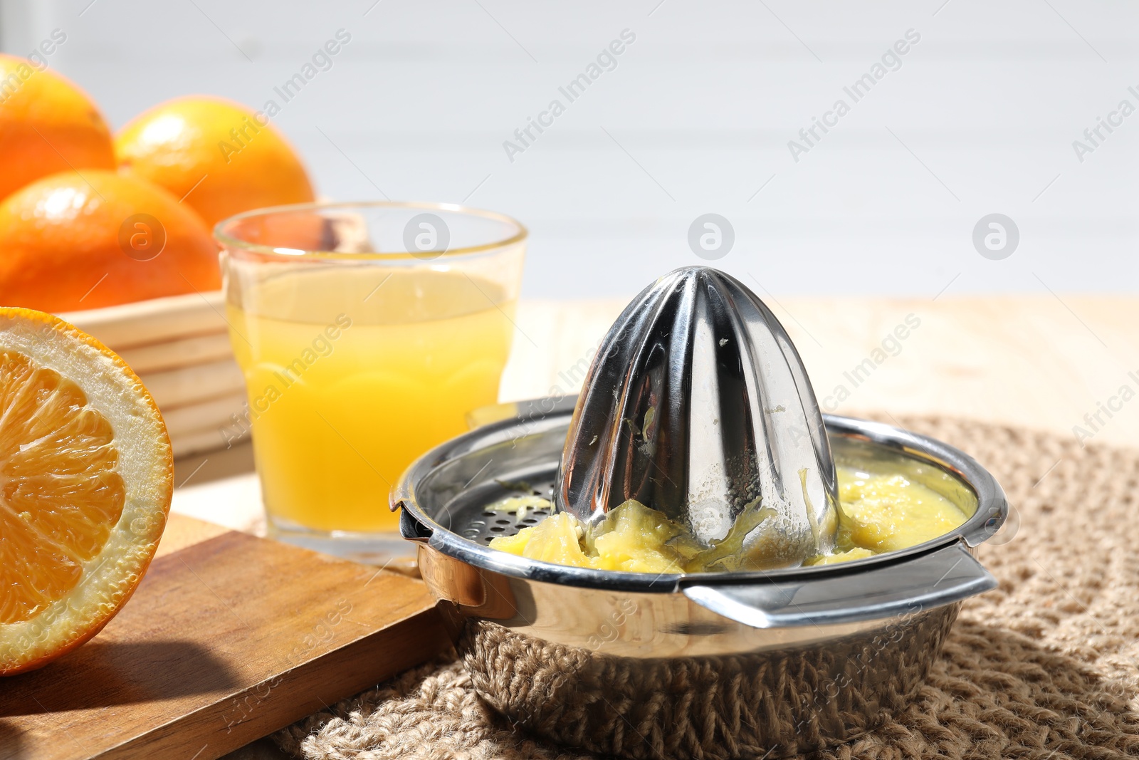 Freshly squeezed orange juice, fruits and juicer on table, closeup Photo of Freshly squeezed orange juice, fruits and juicer on table, closeup