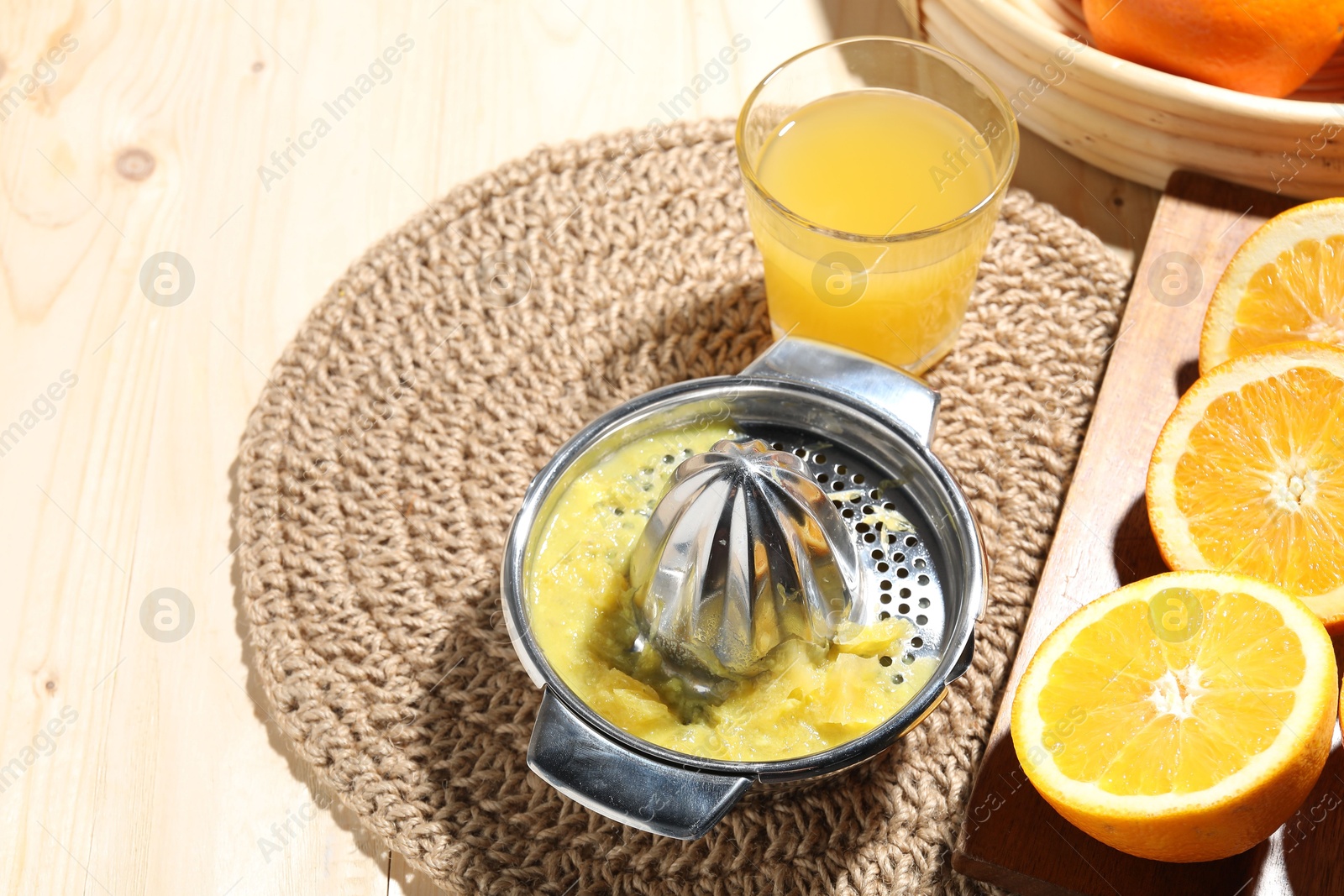 Freshly squeezed orange juice, fruits and juicer on wooden table, above view. Space for text Photo of Freshly squeezed orange juice, fruits and juicer on wooden table, above view. Space for text
