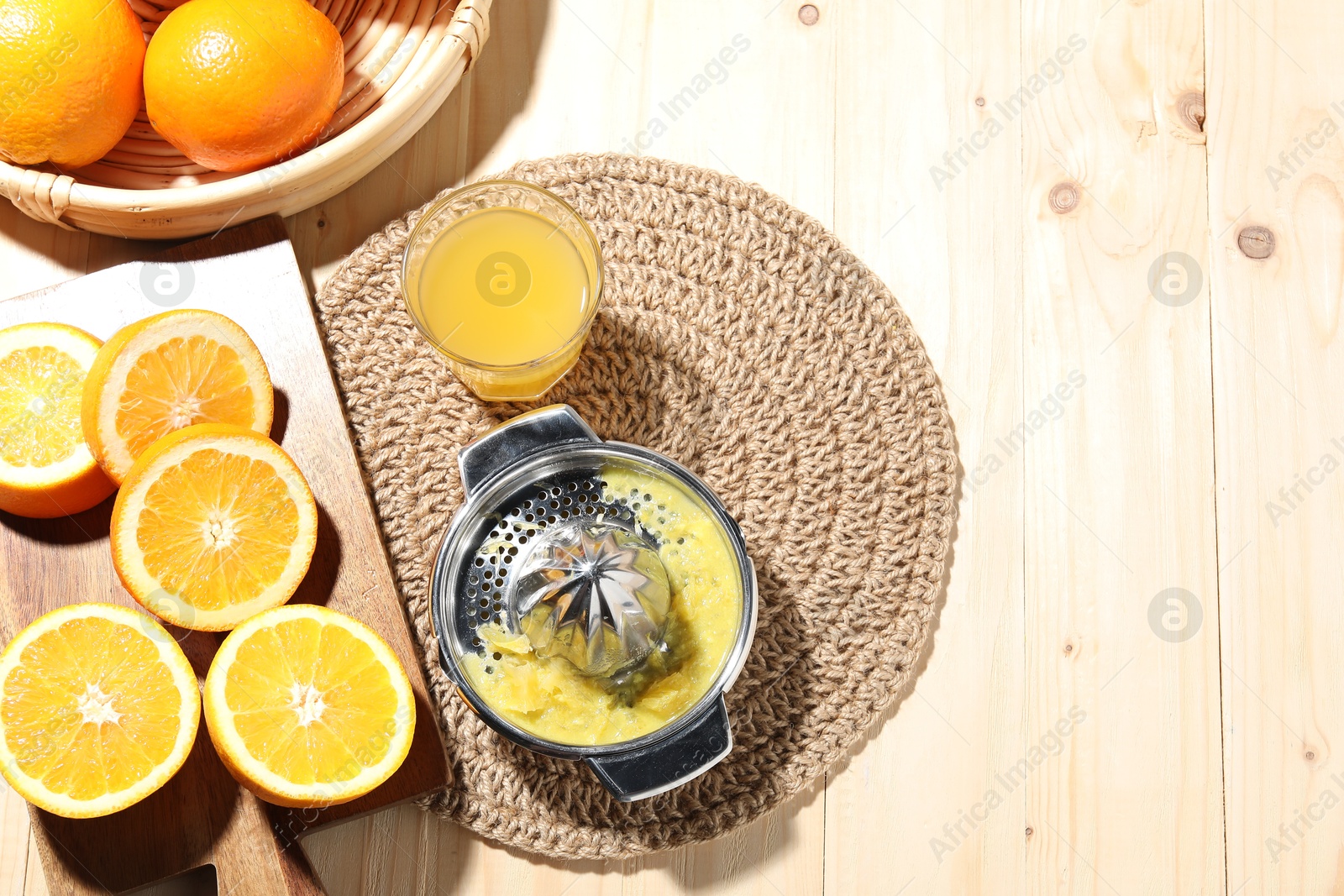 Freshly squeezed orange juice, fruits and juicer on wooden table, flat lay. Space for text Photo of Freshly squeezed orange juice, fruits and juicer on wooden table, flat lay. Space for text