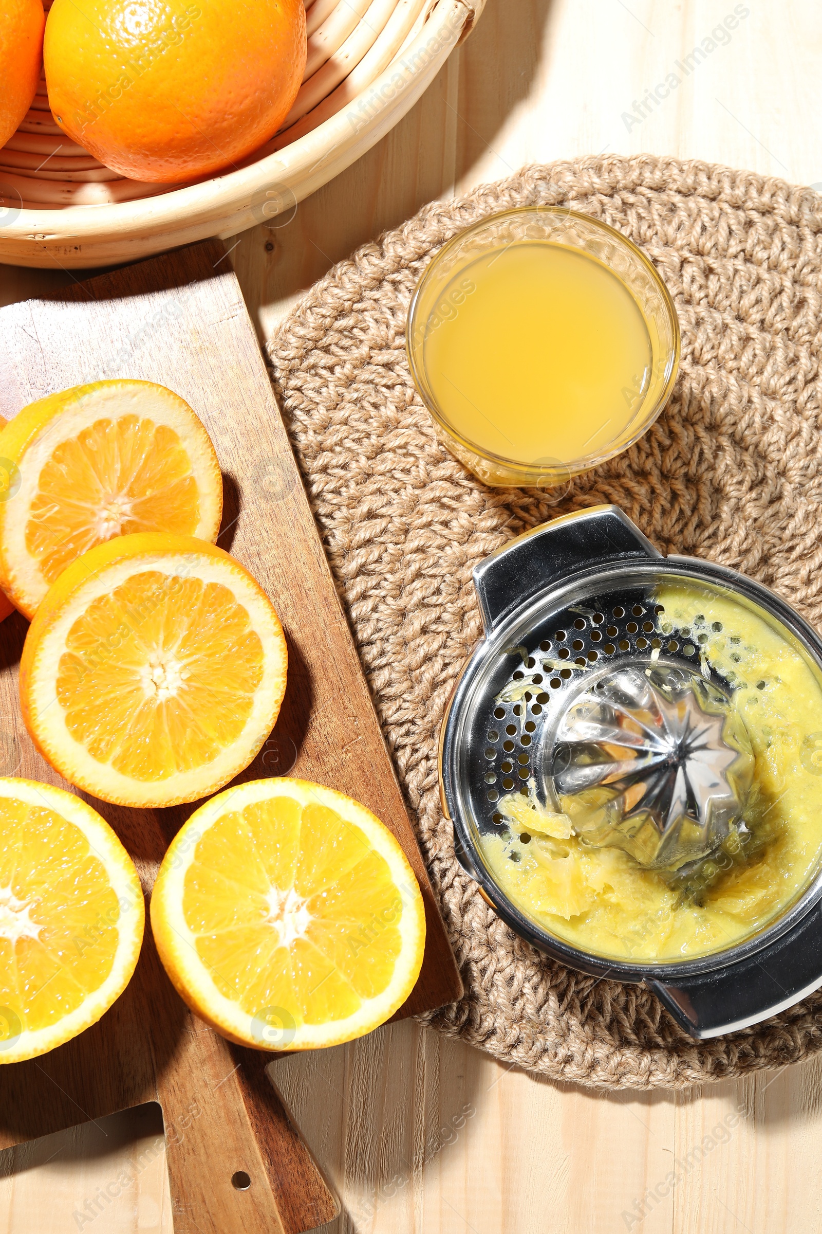 Freshly squeezed orange juice, fruits and juicer on wooden table, flat lay Photo of Freshly squeezed orange juice, fruits and juicer on wooden table, flat lay