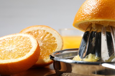 Photo of Making juice. Juicer and fresh fruits on table, closeup