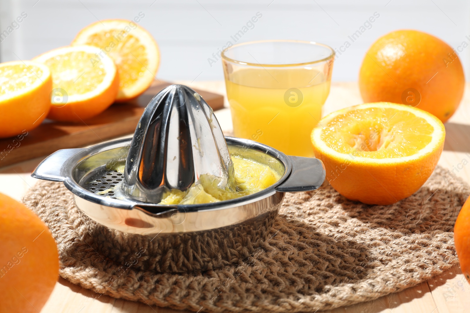 Freshly squeezed orange juice, fruits and juicer on table, closeup Photo of Freshly squeezed orange juice, fruits and juicer on table, closeup