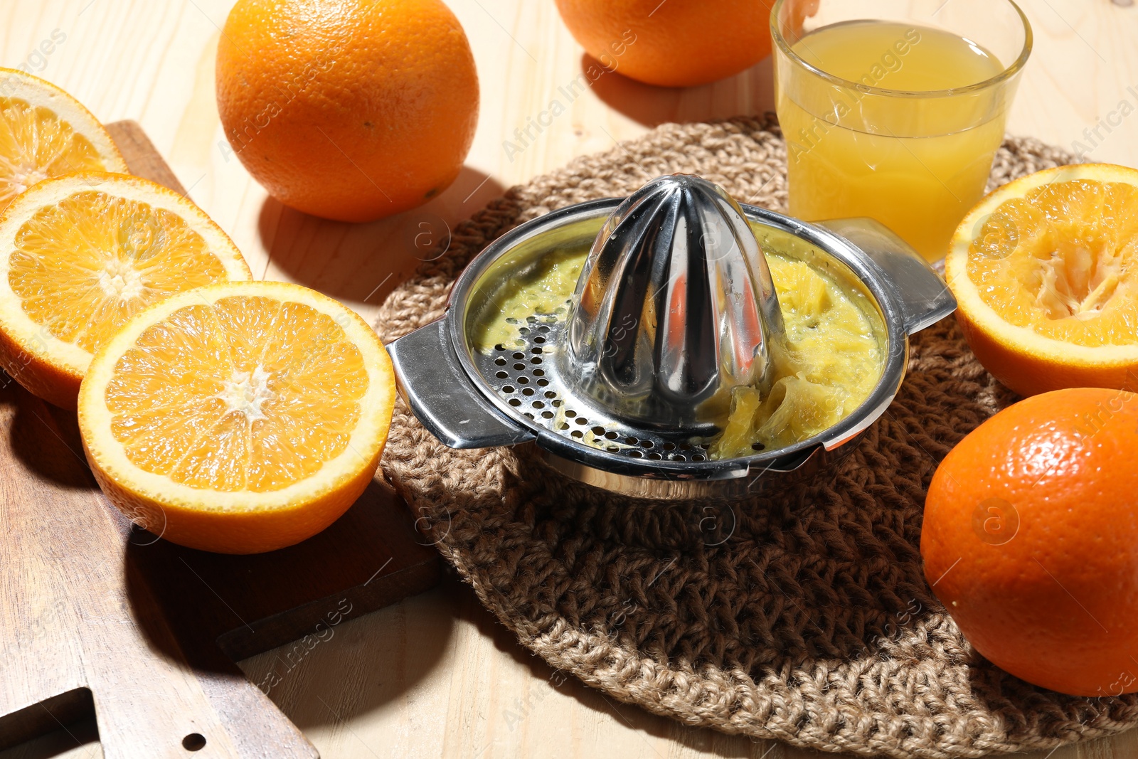 Freshly squeezed orange juice, fruits and juicer on wooden table, closeup Photo of Freshly squeezed orange juice, fruits and juicer on wooden table, closeup