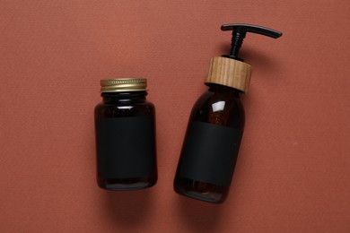 Photo of Cosmetic products on brown background, flat lay. Mockup for design