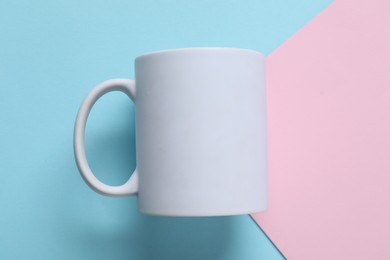 Photo of White mug on color background, top view. Mockup for design