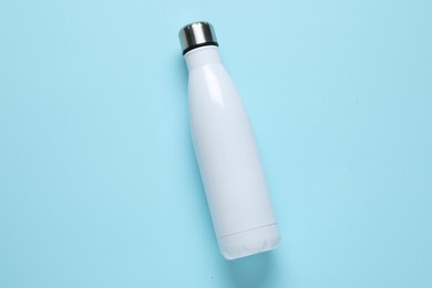 Photo of Water bottle on light blue background, top view