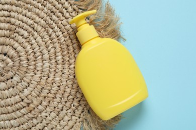 Photo of Cosmetic product and wicker mat on light blue background, top view. Mockup for design