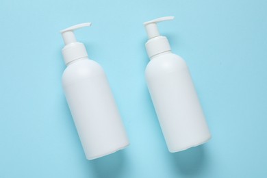 Photo of Cosmetic products on light blue background, flat lay. Mockup for design