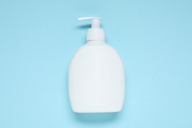 Photo of Cosmetic product on light blue background, top view. Mockup for design