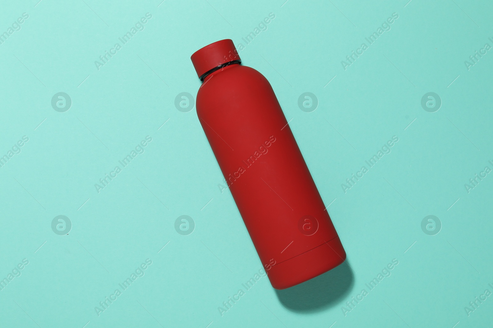 Water bottle on turquoise background, top view Photo of Water bottle on turquoise background, top view
