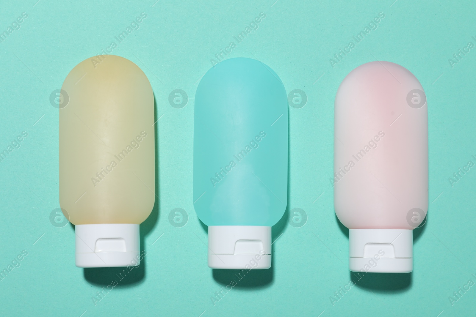 Cosmetic products on turquoise background, flat lay. Mockup for design Photo of Cosmetic products on turquoise background, flat lay. Mockup for design