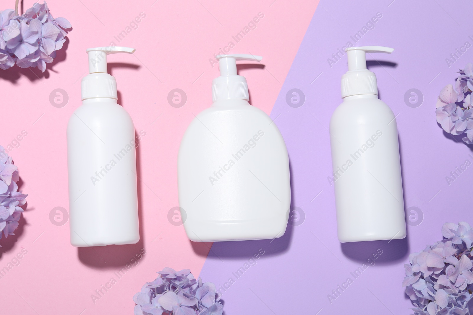 Cosmetic products and flowers on color background, flat lay. Mockup for design Photo of Cosmetic products and flowers on color background, flat lay. Mockup for design