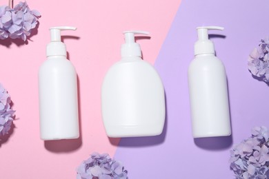 Photo of Cosmetic products and flowers on color background, flat lay. Mockup for design