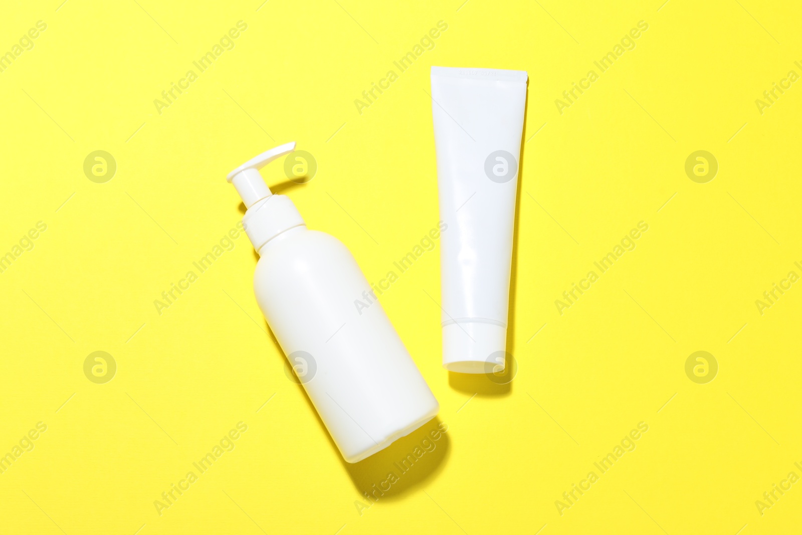 Cosmetic products on yellow background, flat lay. Mockup for design Photo of Cosmetic products on yellow background, flat lay. Mockup for design