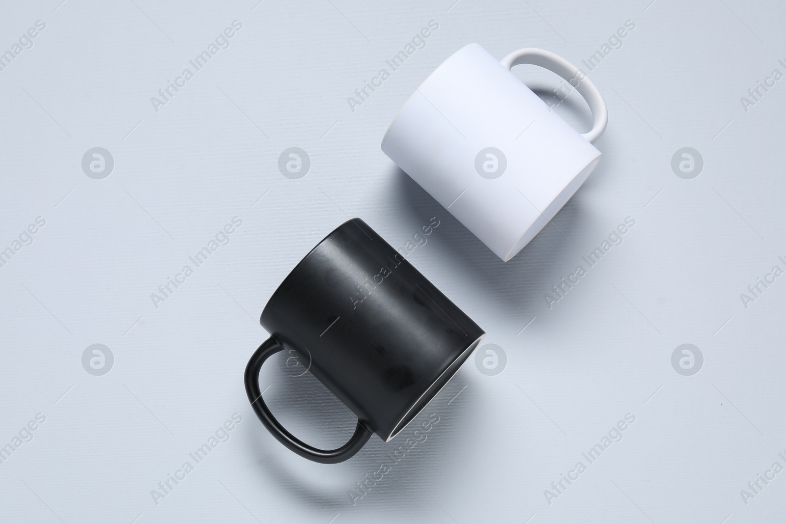 Mugs on light background, top view. Mockup for design Photo of Mugs on light background, top view. Mockup for design