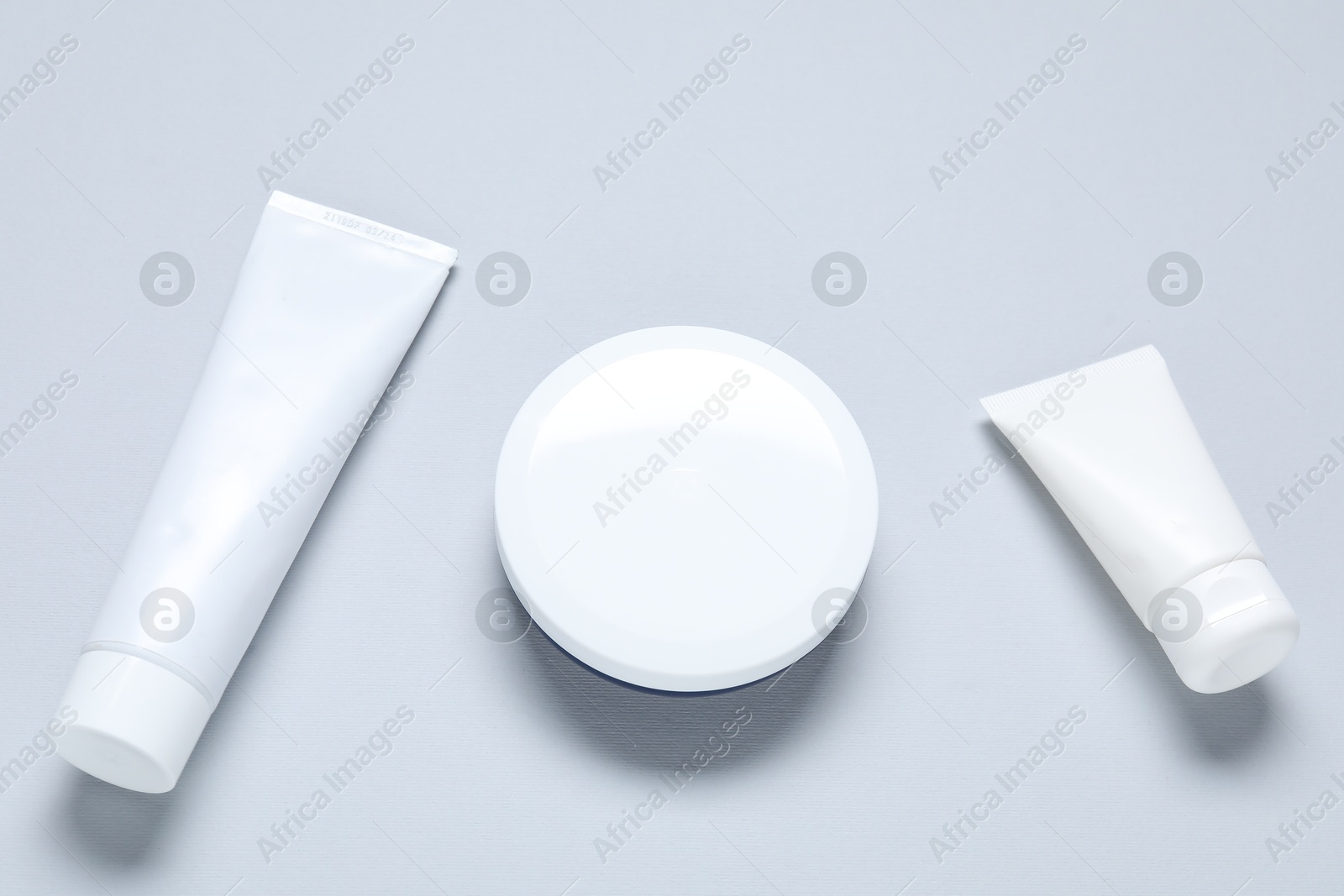 Cosmetic products on light background, flat lay. Mockup for design Photo of Cosmetic products on light background, flat lay. Mockup for design