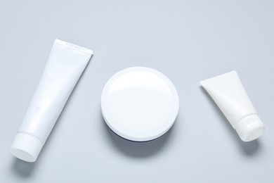 Photo of Cosmetic products on light background, flat lay. Mockup for design