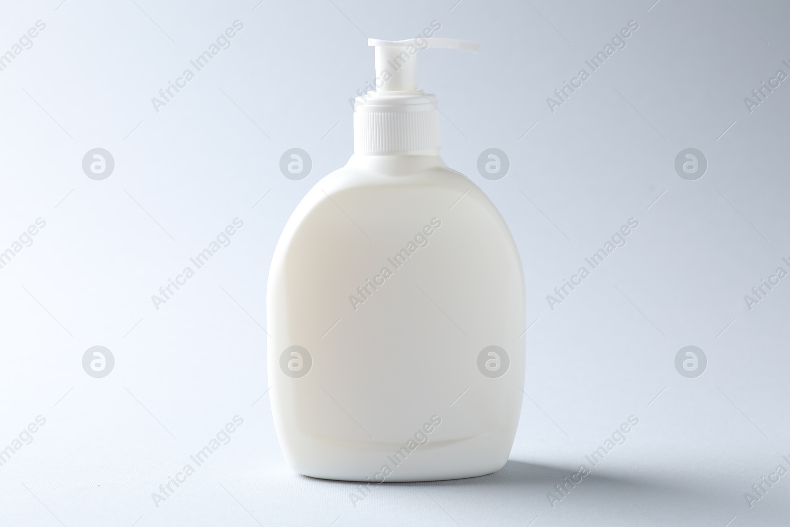 Bottle of cosmetic product on light background. Mockup for design Photo of Bottle of cosmetic product on light background. Mockup for design