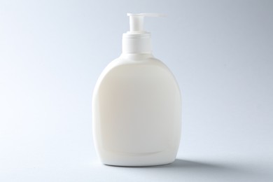Photo of Bottle of cosmetic product on light background. Mockup for design
