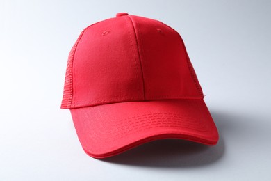Photo of Red cap on light background. Mockup for design