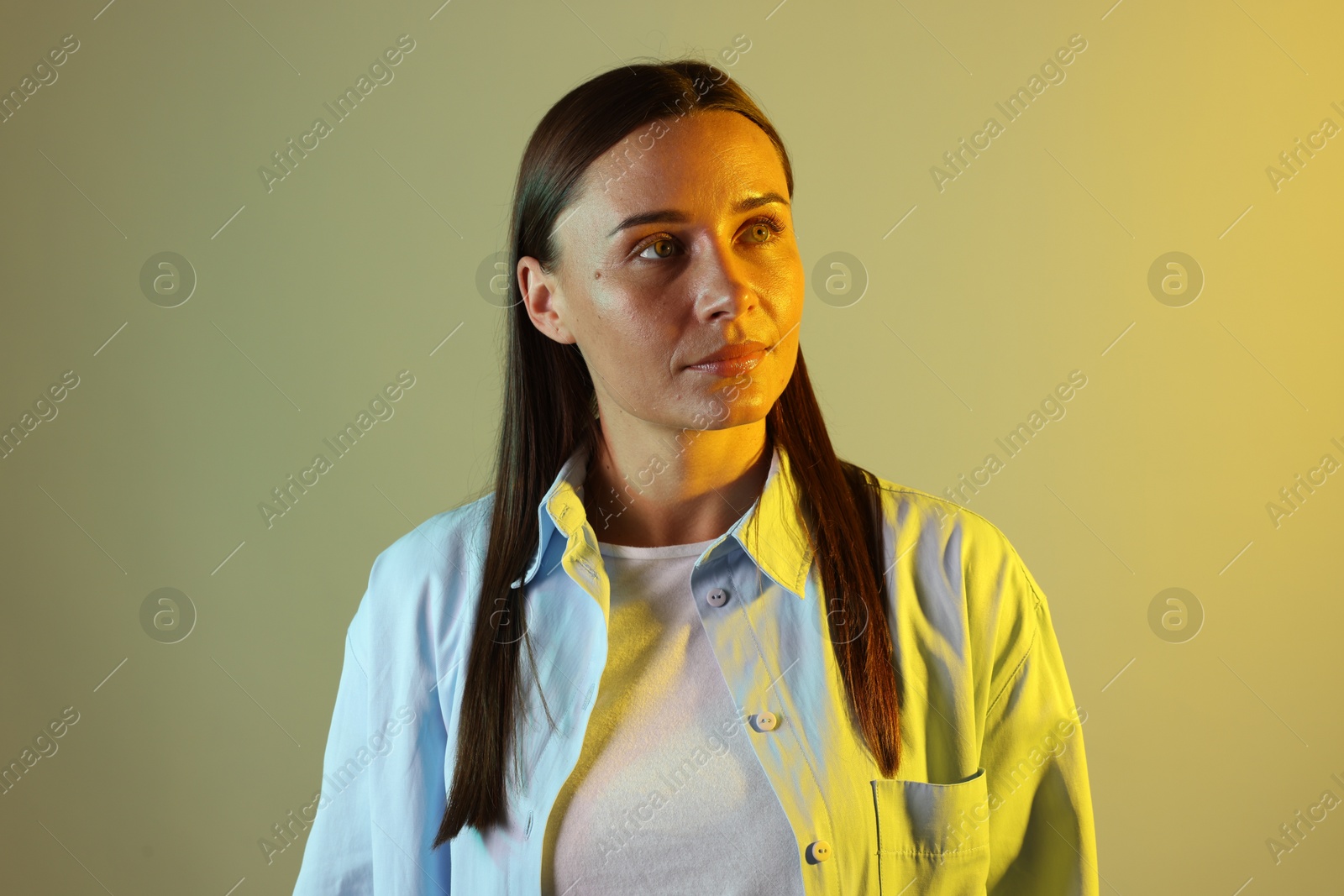 Photo of Beautiful woman in neon lights against color background