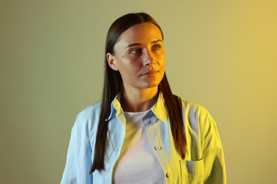 Photo of Beautiful woman in neon lights against color background