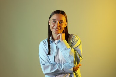 Photo of Smiling woman in neon lights against color background