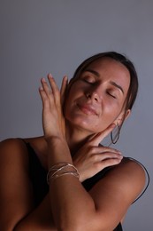 Photo of Beautiful woman with bracelet on grey background