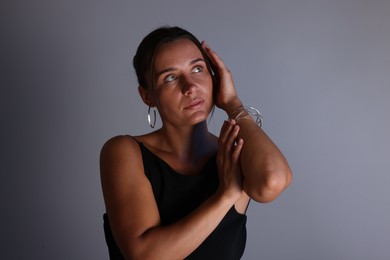 Photo of Beautiful woman with bracelet on grey background