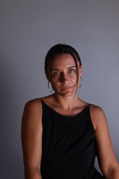 Photo of Portrait of beautiful woman on grey background