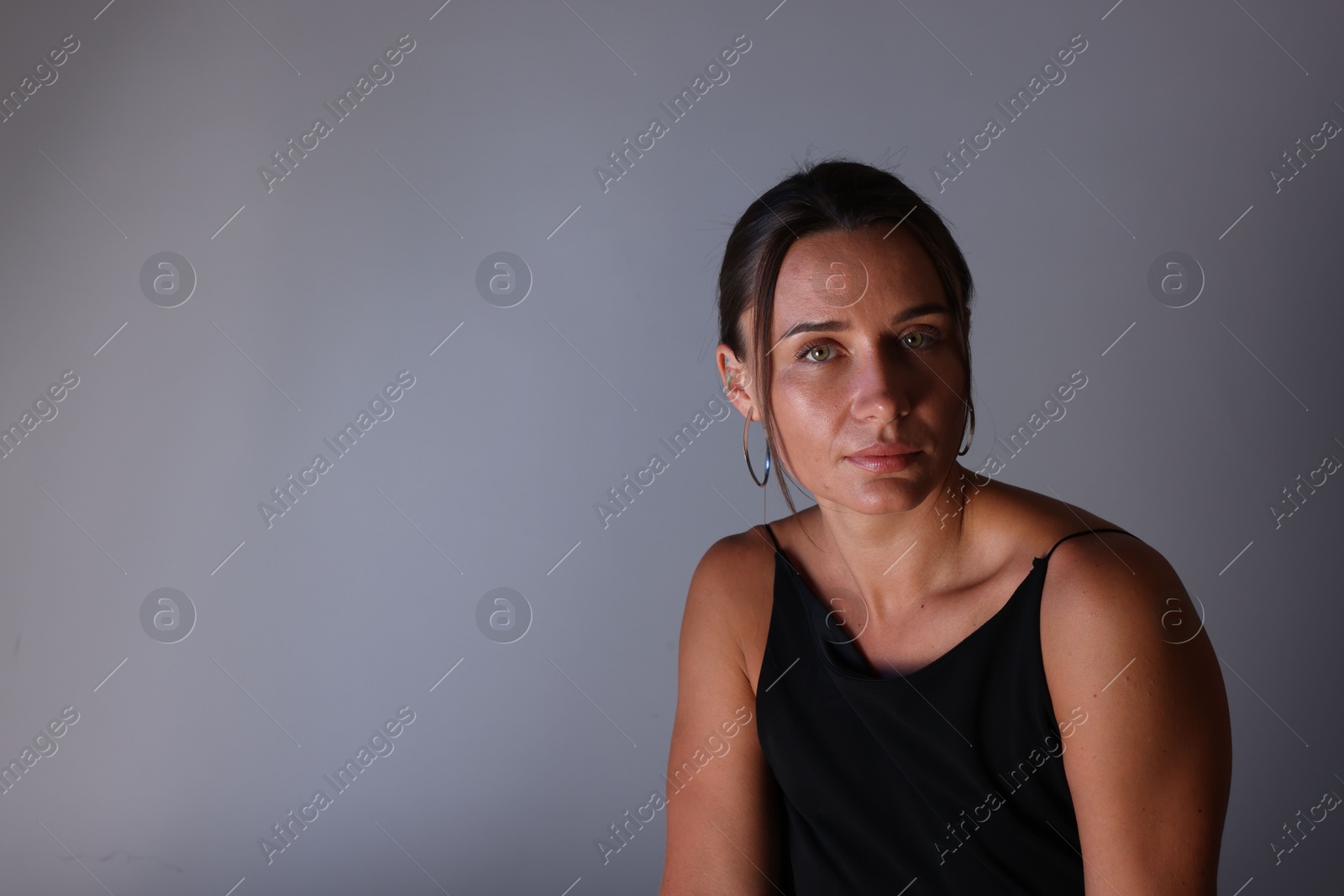 Portrait of beautiful woman on grey background. Space for text Photo of Portrait of beautiful woman on grey background. Space for text