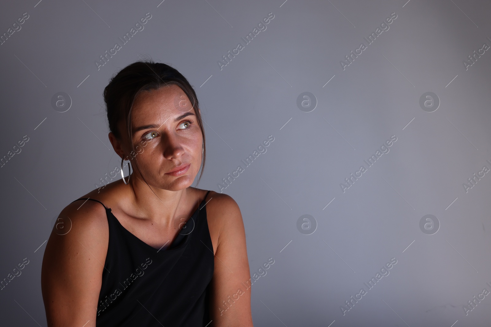 Beautiful woman on grey background. Space for text Photo of Beautiful woman on grey background. Space for text
