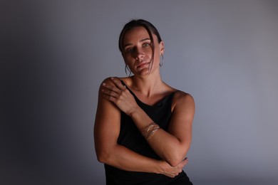 Photo of Portrait of beautiful woman with bracelet on grey background