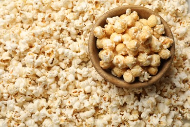 Photo of Tasty popcorn and bowl as background, closeup