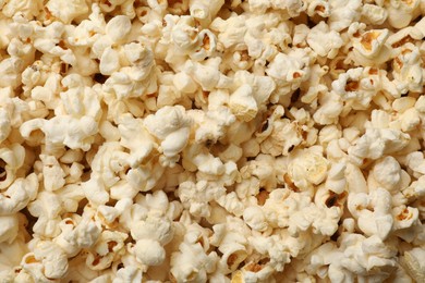Photo of Fresh tasty popcorn as background, closeup view