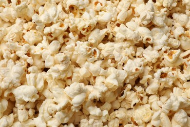 Photo of Fresh tasty popcorn as background, closeup view