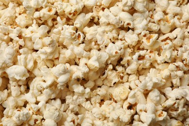 Photo of Fresh tasty popcorn as background, closeup view