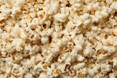Photo of Fresh tasty popcorn as background, closeup view
