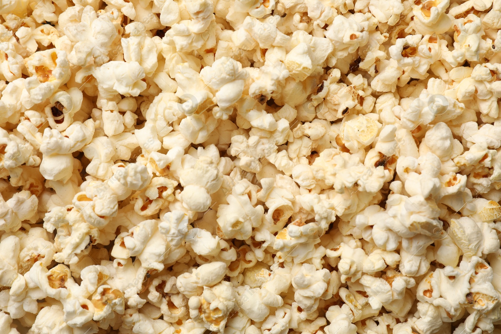 Fresh tasty popcorn as background, closeup view Photo of Fresh tasty popcorn as background, closeup view