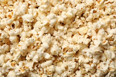 Photo of Fresh tasty popcorn as background, closeup view