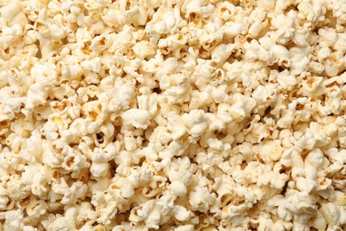 Photo of Fresh tasty popcorn as background, closeup view